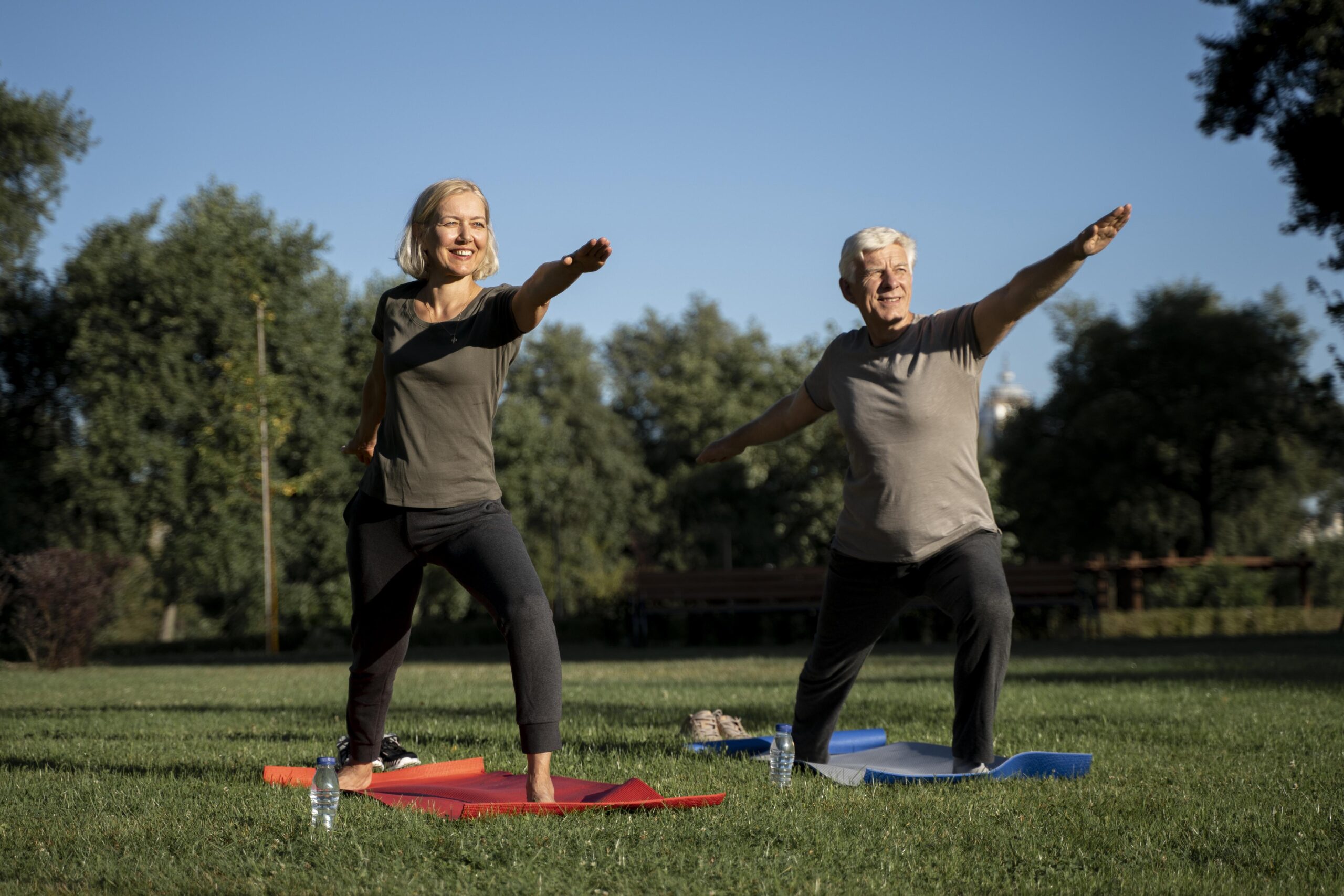 mature couple practicing yoga outside